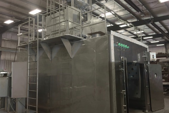 Stainless smokehouse chamber with control panel in a meat processing plant